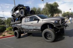 A Polaris RZR rides piggyback in the bed of the Ram pickup truck